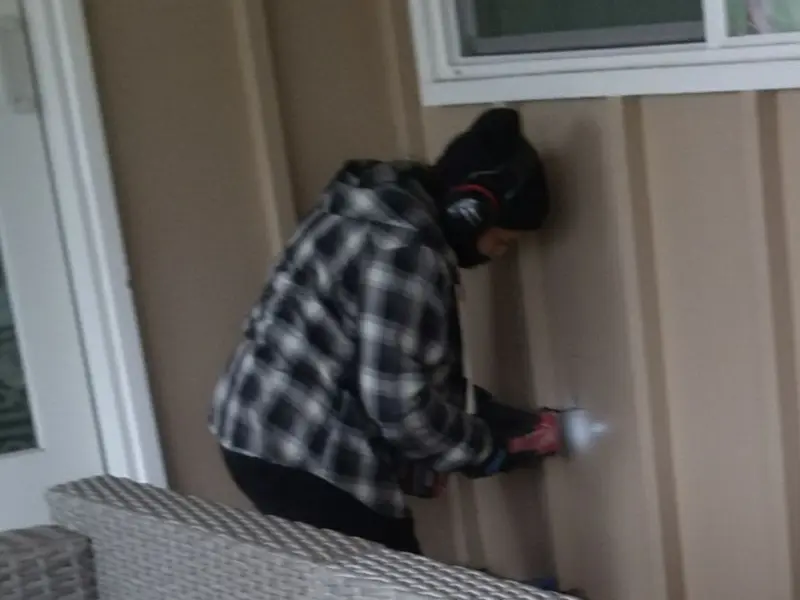 Professional electrician installing an exterior outlet in Huron